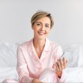 happy-woman-sitting-in-bed-using-cell-phone-2022-01-19-00-11-50-utc-e1659175295343.jpg happy-woman-sitting-in-bed-using-cell-phone-2022-01-19-00-11-50-utc-e1659175295343.jpg
